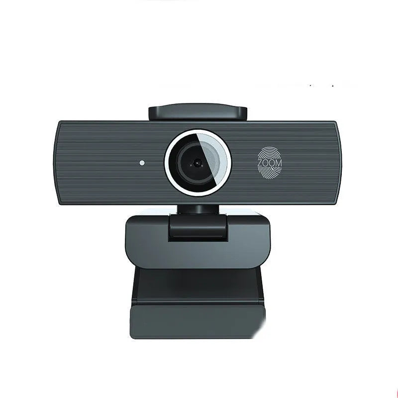 Black 4K USB webcam with auto focus on a desktop, shown with its magnetic privacy cover.