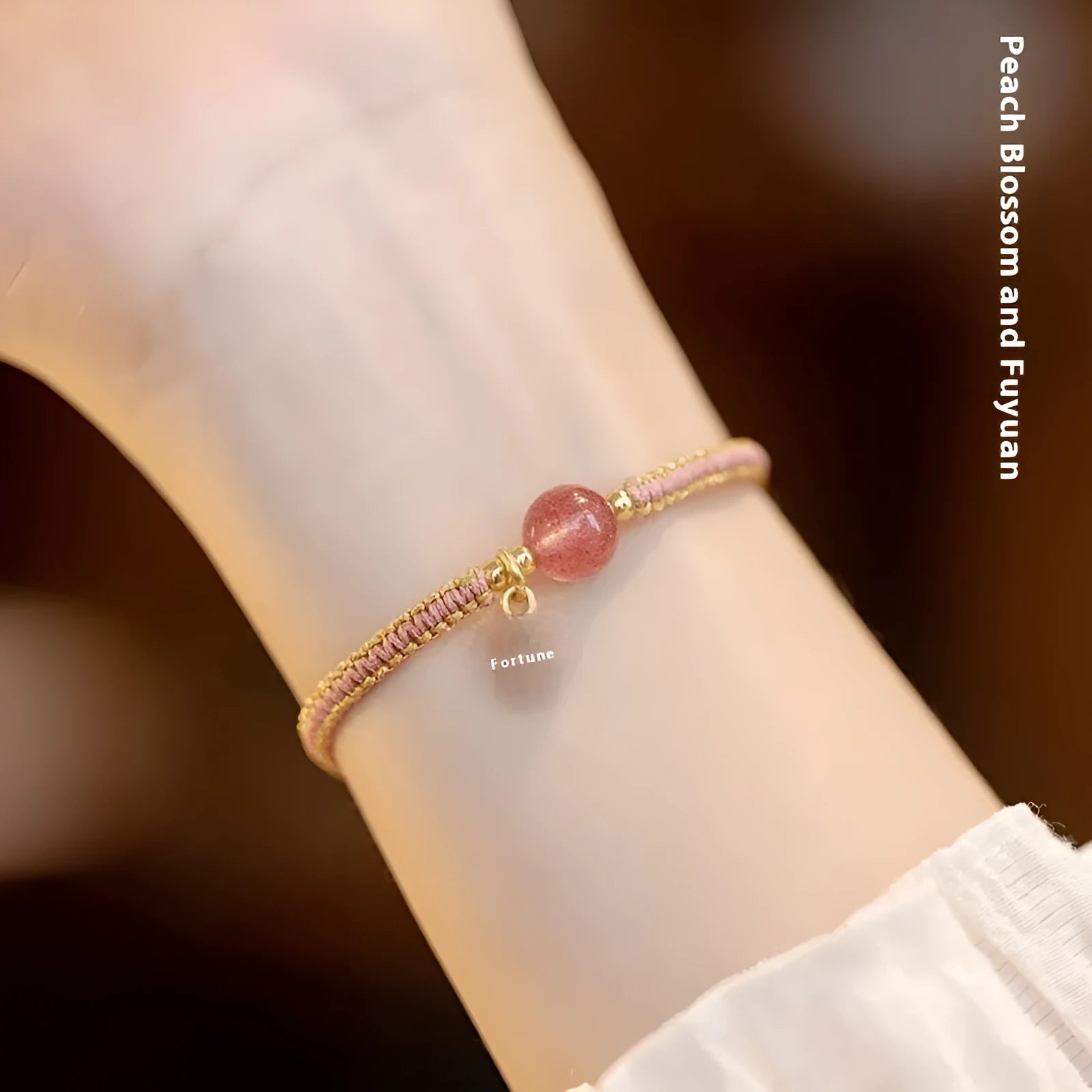 Adjustable red rope bracelet with a choice of Strawberry Quartz or Hetian Jade bead, showing the national style design.