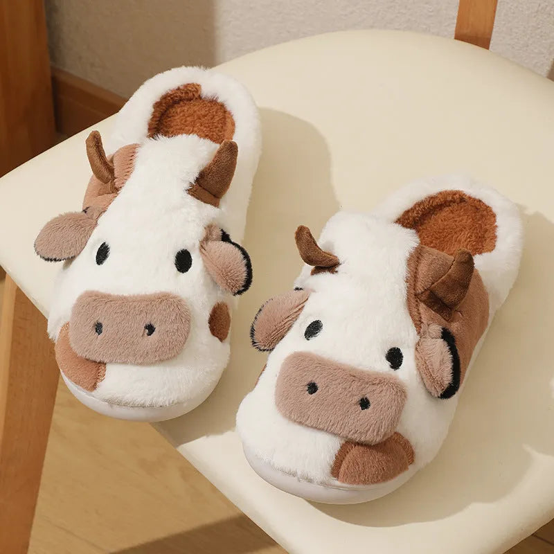White women's cow slippers with fluffy faux fur, cartoon face, and textured non-slip sole.