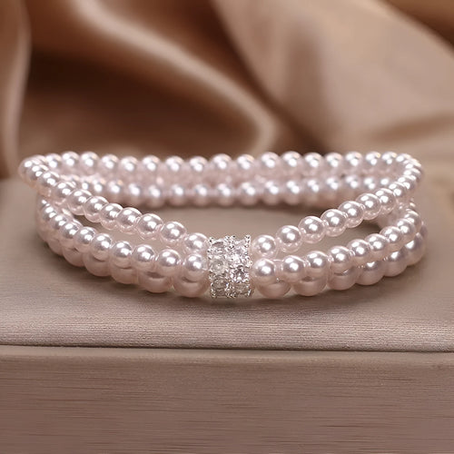Baroque pearl multi-layer twin bracelet with pink and white imitation pearl beads on display