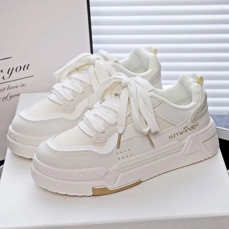 Beige children's board shoes with cross-body straps, thick rubber sole, and front laces on a neutral background.