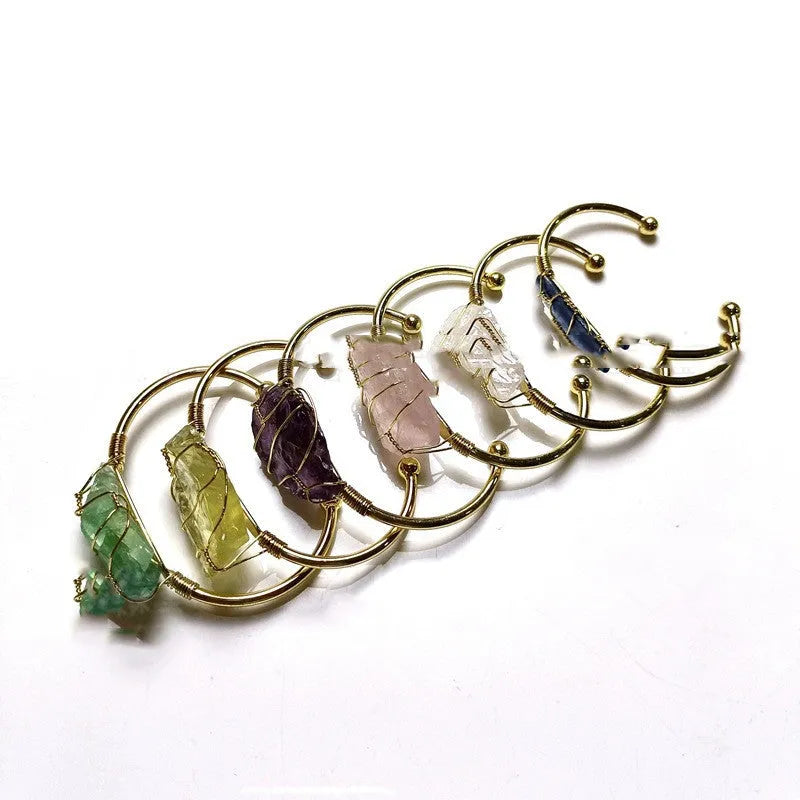 Unisex geometric bracelet made from rough natural crystals with gold metal winding.