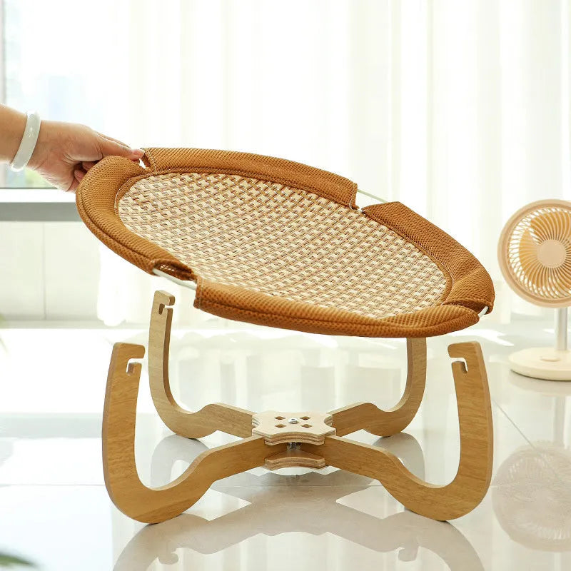 Brown woven rattan pet hammock bed raised off the ground
