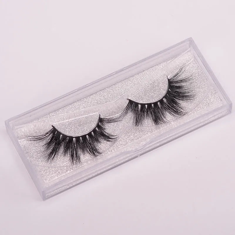 5D mink false eyelashes set with hair cap and double-headed brush on a white background.