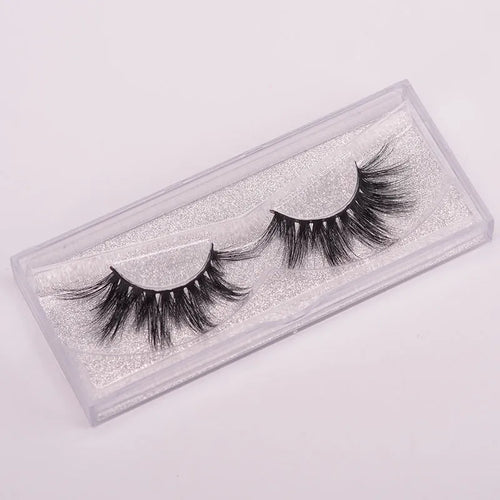 5D mink false eyelashes set with hair cap and double-headed brush on a white background.