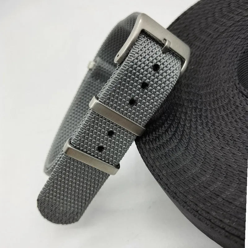 Nylon integrated watch strap in army green colour showing textile texture and buckle.