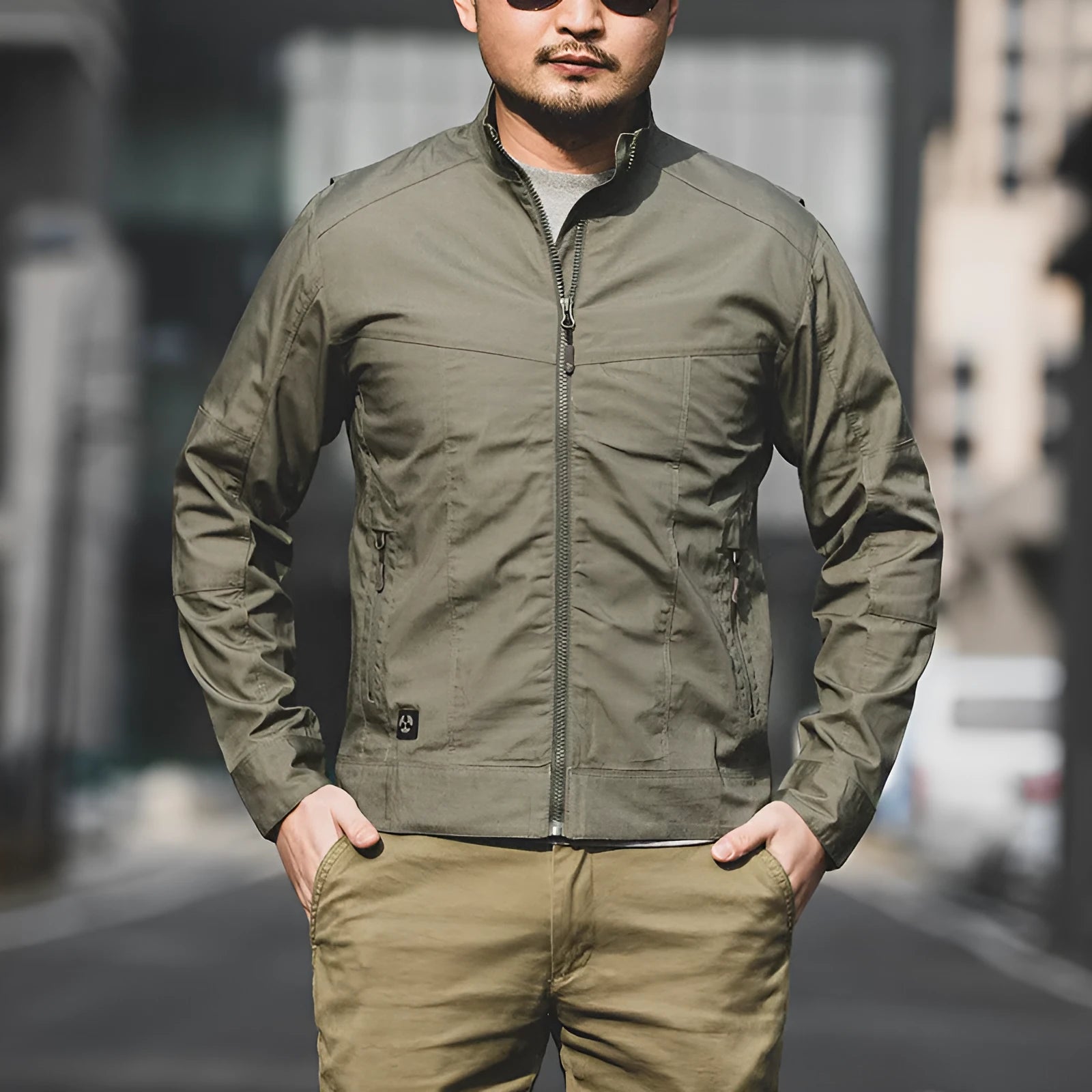 Men's brown plaid tactical camouflage jacket with multiple pockets on a man outdoors.