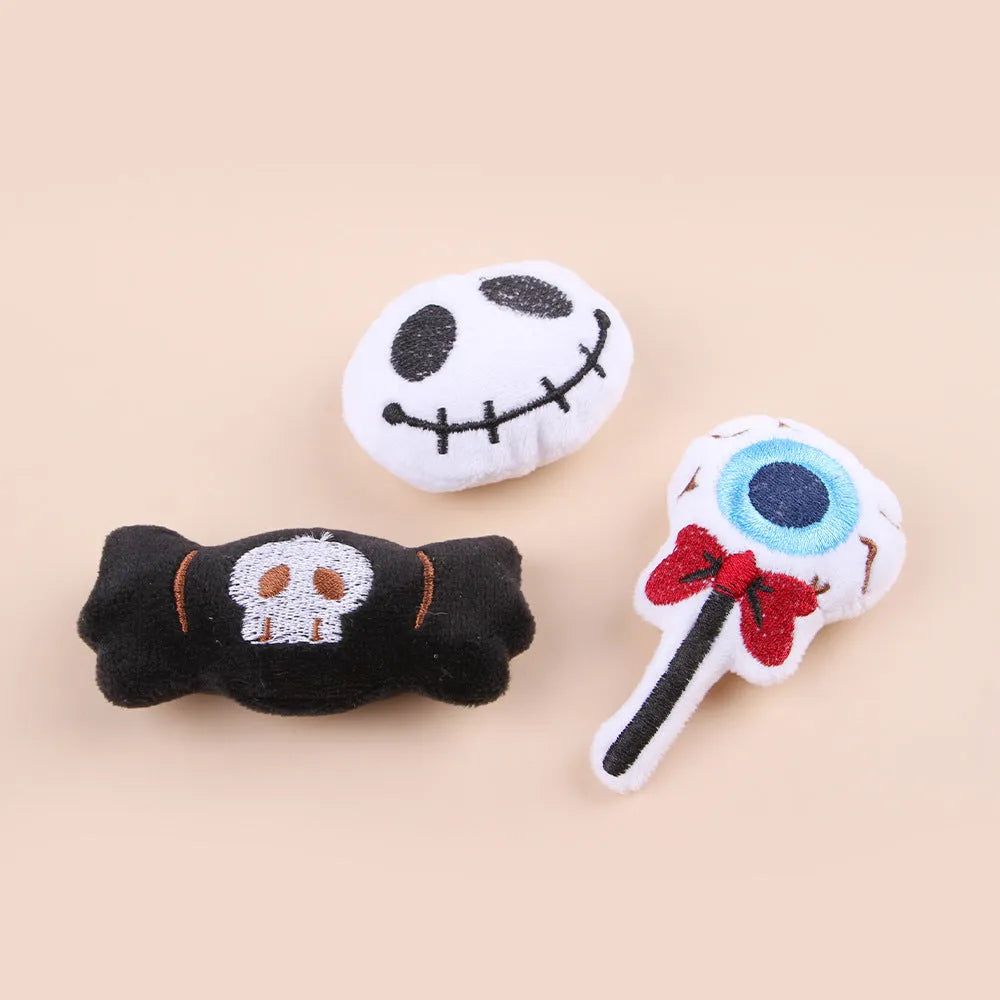 Small cat teaser wand toy with plush candy and skull attachments on string