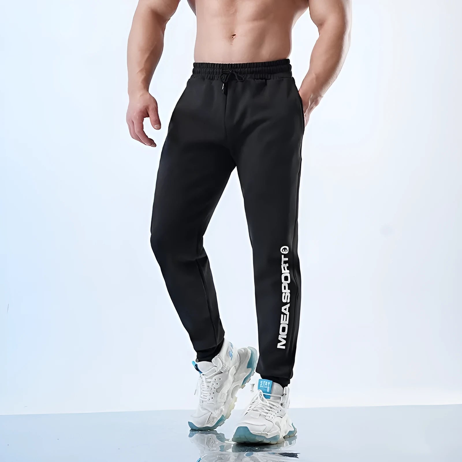 Men's grey blue ankle-tied sweatpants with mid waist, shown on a model.