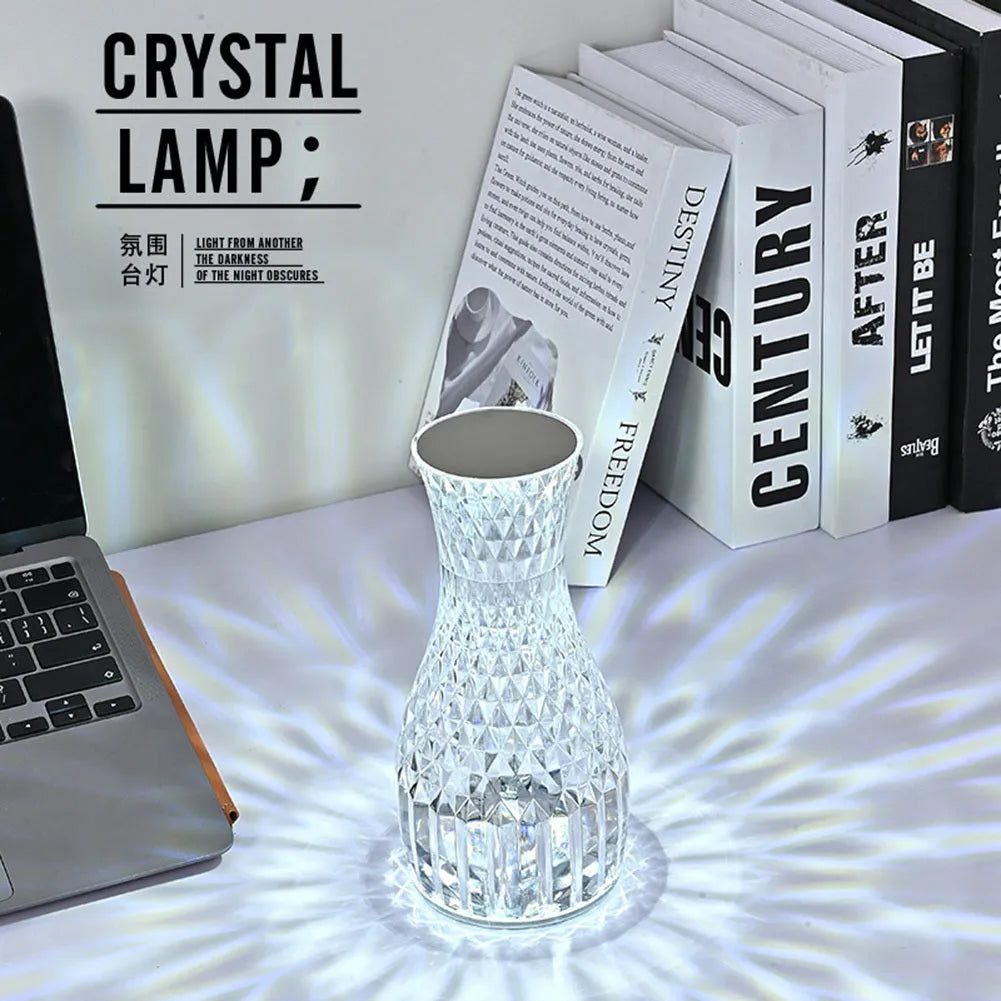 Vase-shaped crystal table lamp with diamond-like LED lighting on wooden surface