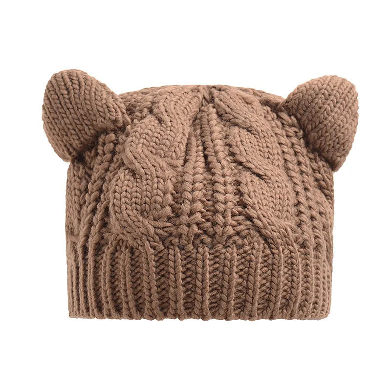 Hand knitted red wool beanie with 3D cat ears on a white background