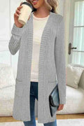 Long sleeve loose cardigan jacket in black, wine red, or grey with pockets, shown on a hanger.