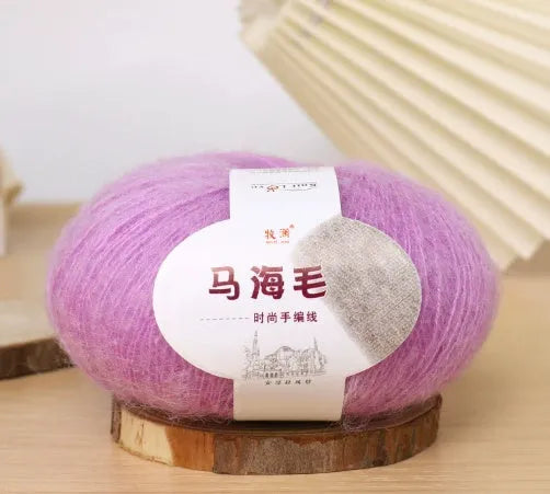 Ball of mohair yarn for DIY scarf knitting in one of 34 colours, including white, pink, blue, and green.