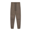 Men's loose-fit grey fitness trousers with elasticated ankle cuffs on a plain background.