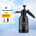 Black hand-held pressure sprayer with 2-litre capacity and two nozzles for garden and car cleaning