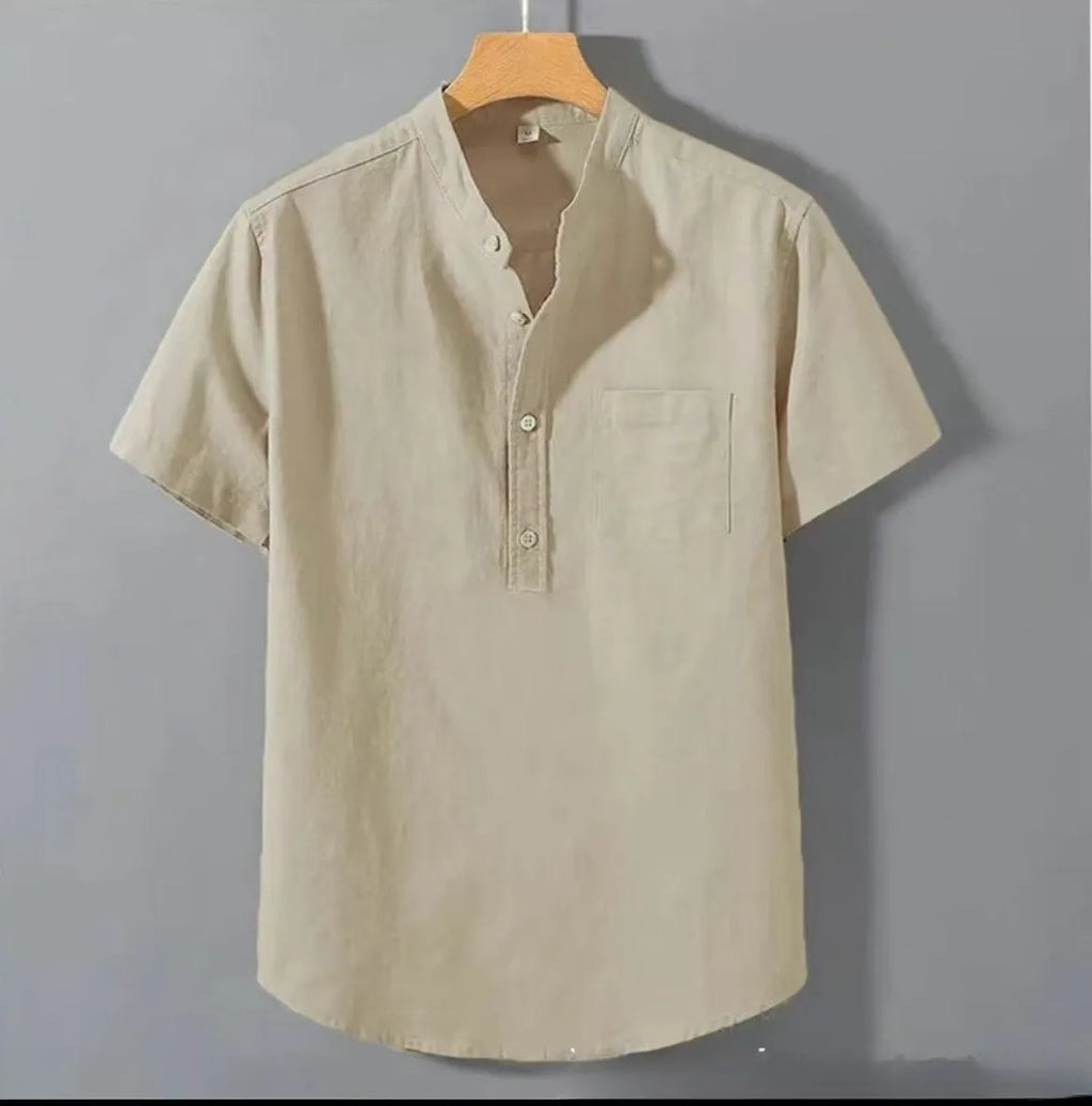 Man wearing a beige slub linen casual shirt with a stand collar and short sleeves.