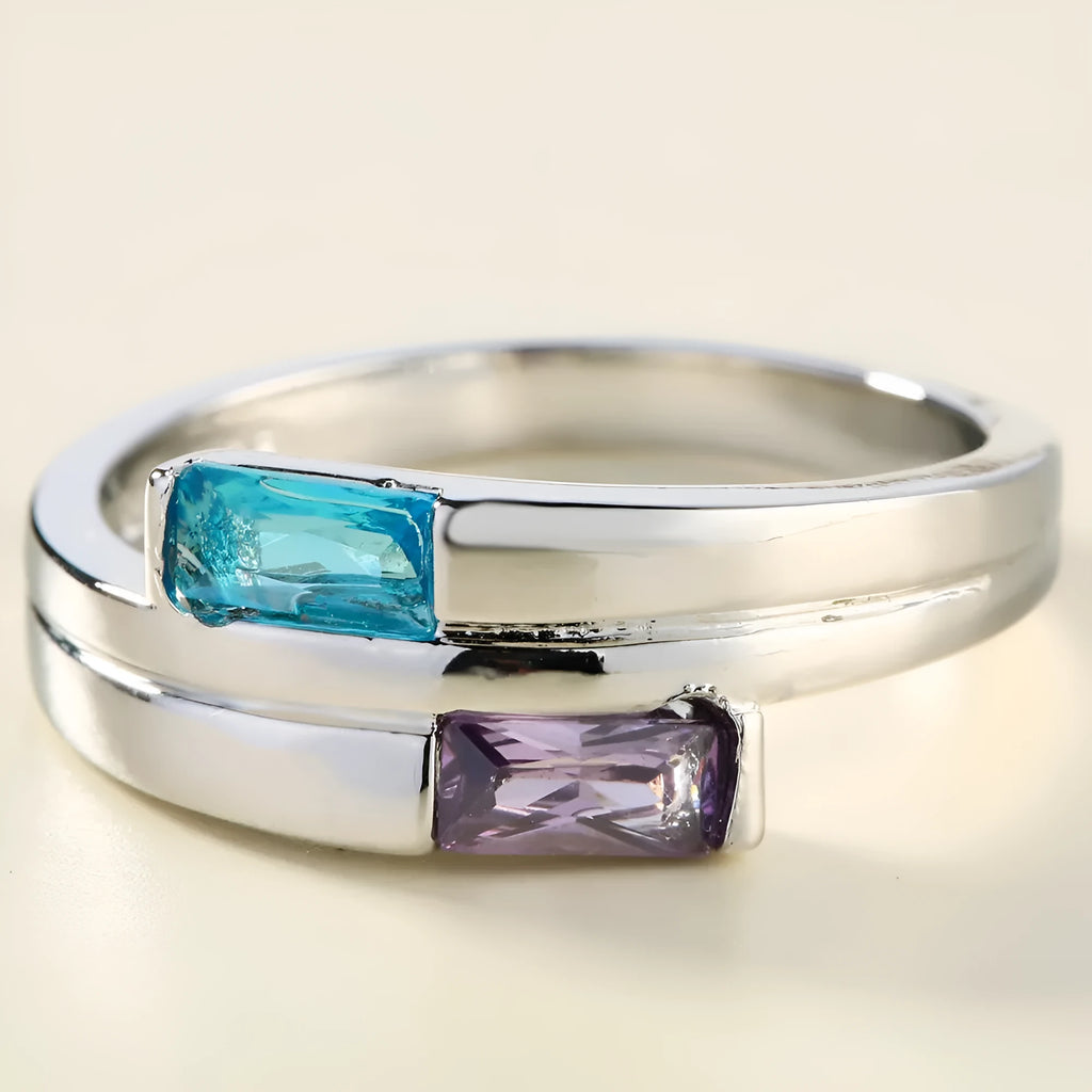 Copper ring with a silver electroplated finish and a central zircon stone, shown on a finger.