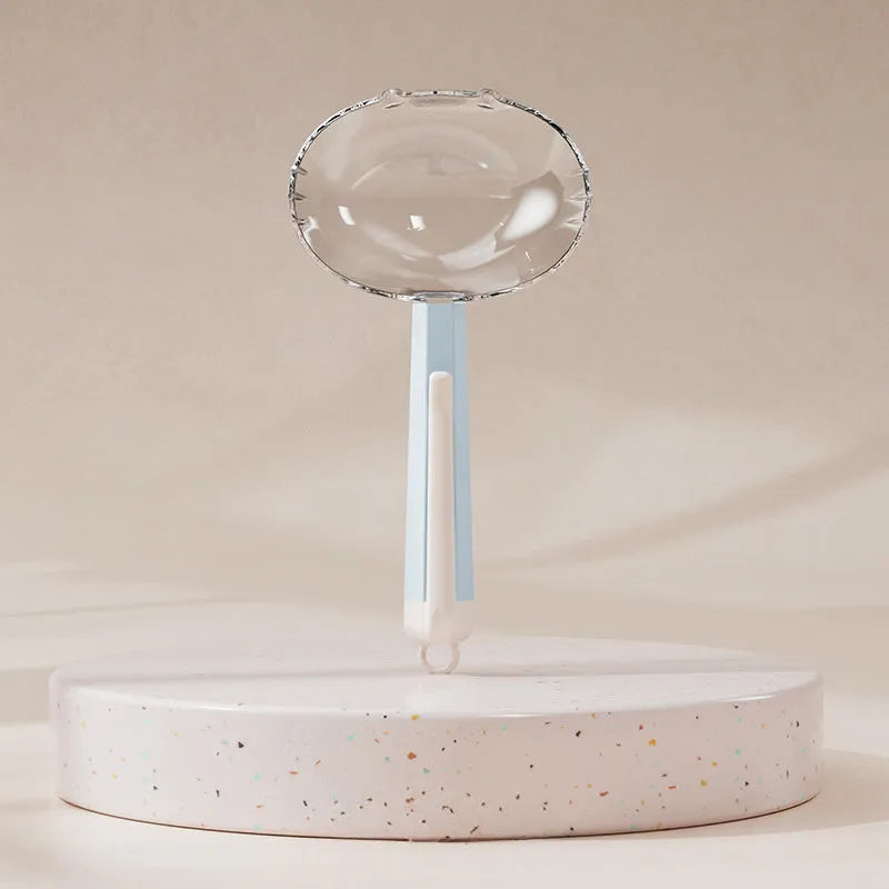Blue pet food spoon with metal clip attached to a dog food tin.