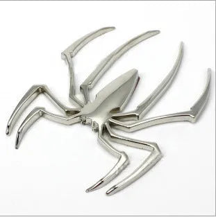 Three-dimensional metal spider car bumper sticker in gold, silver, black, and red colour options.