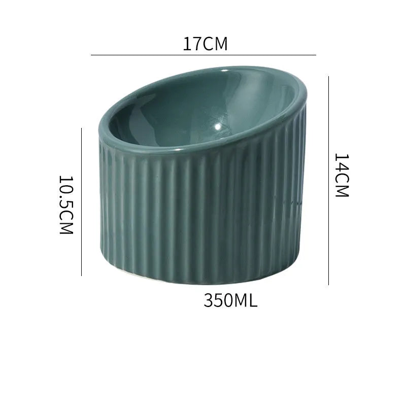 Elevated ceramic cat bowl in light green, showing tilted design and round whisker-friendly shape