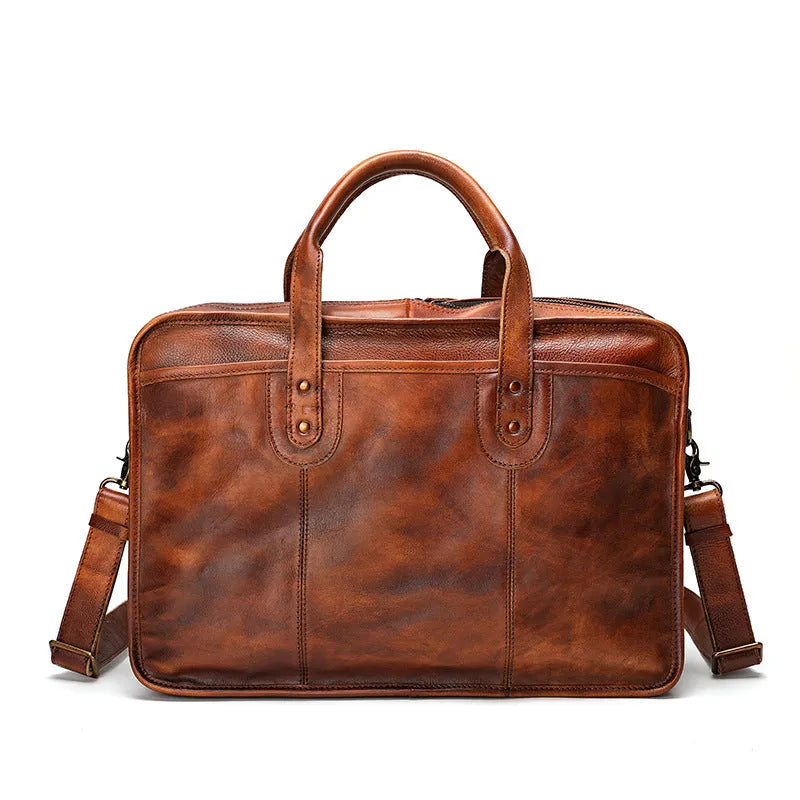 Vintage style brown leather men's briefcase showing internal organisation pockets and soft handle.