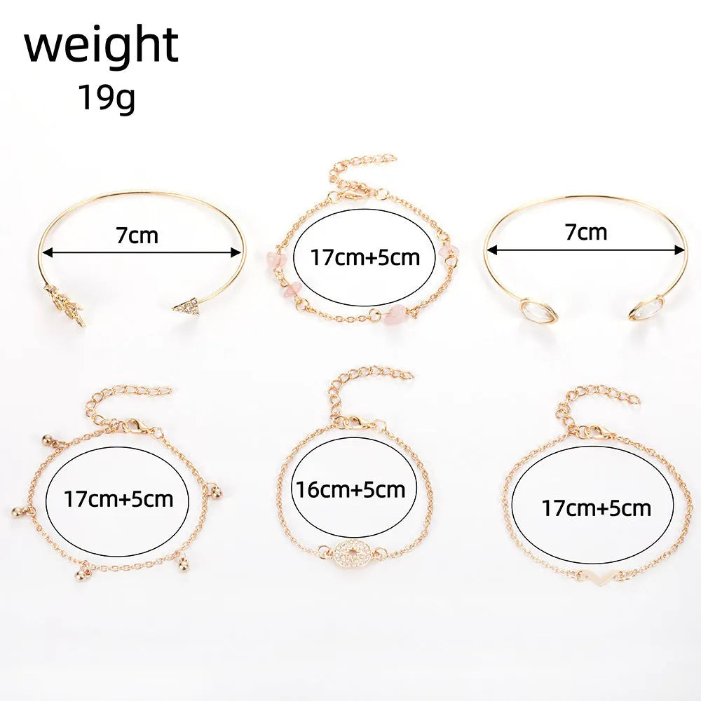 Set of six gold bracelets with arrow, water drop, and V shapes featuring spot drill detail.