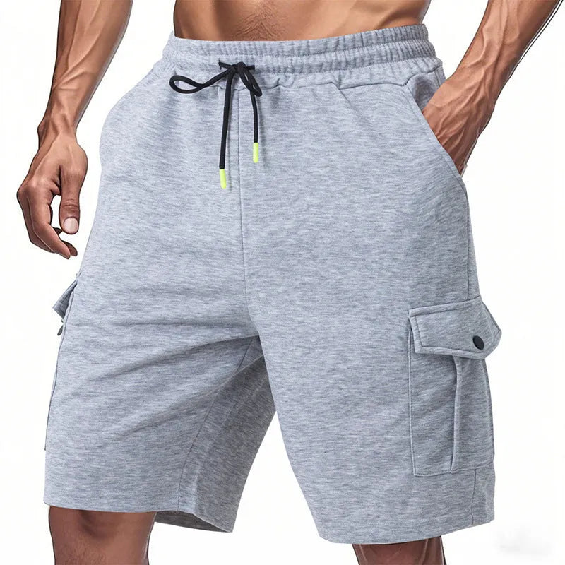 Men's loose-fit grey terry fabric cargo shorts with multiple pockets on a plain background.