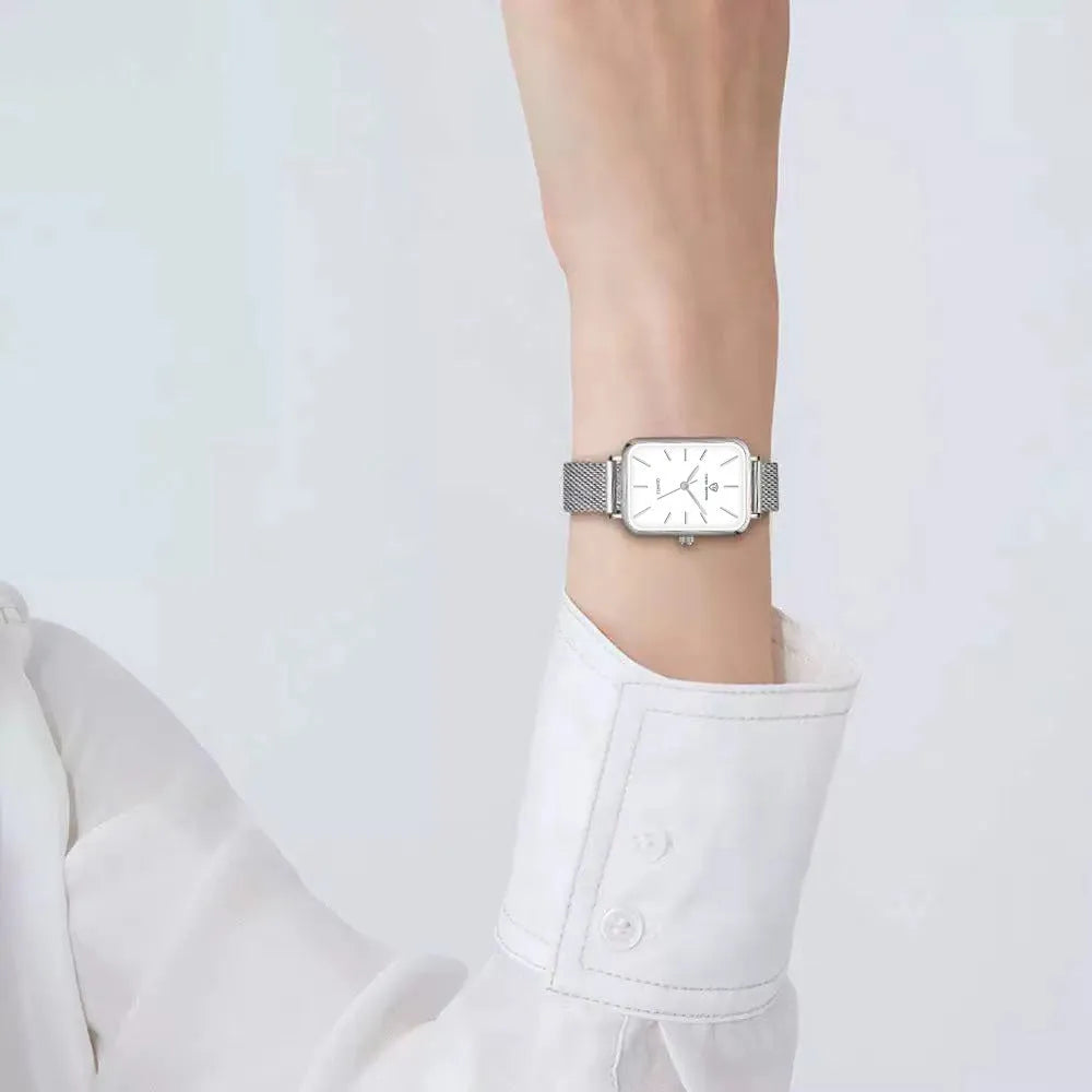 Women's rose gold quartz watch with woven steel strap and alloy case.