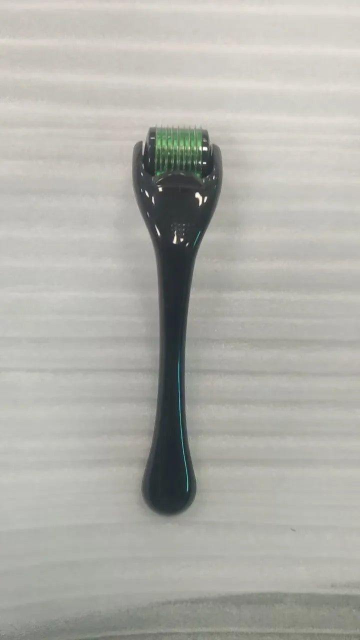 540 micro needle roller tool with black handle and coloured wheel on a white background.