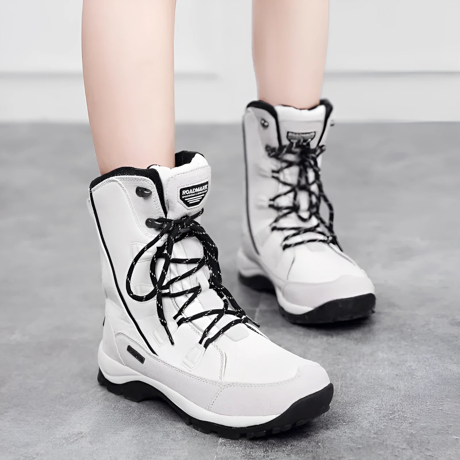 Women's black genuine leather mid-calf snow boots with round toe and thermal lining on a white background.