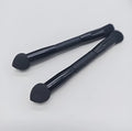 Double-headed concealer brush with black wooden handle, artificial fibre bristles, and angled sponge tip.