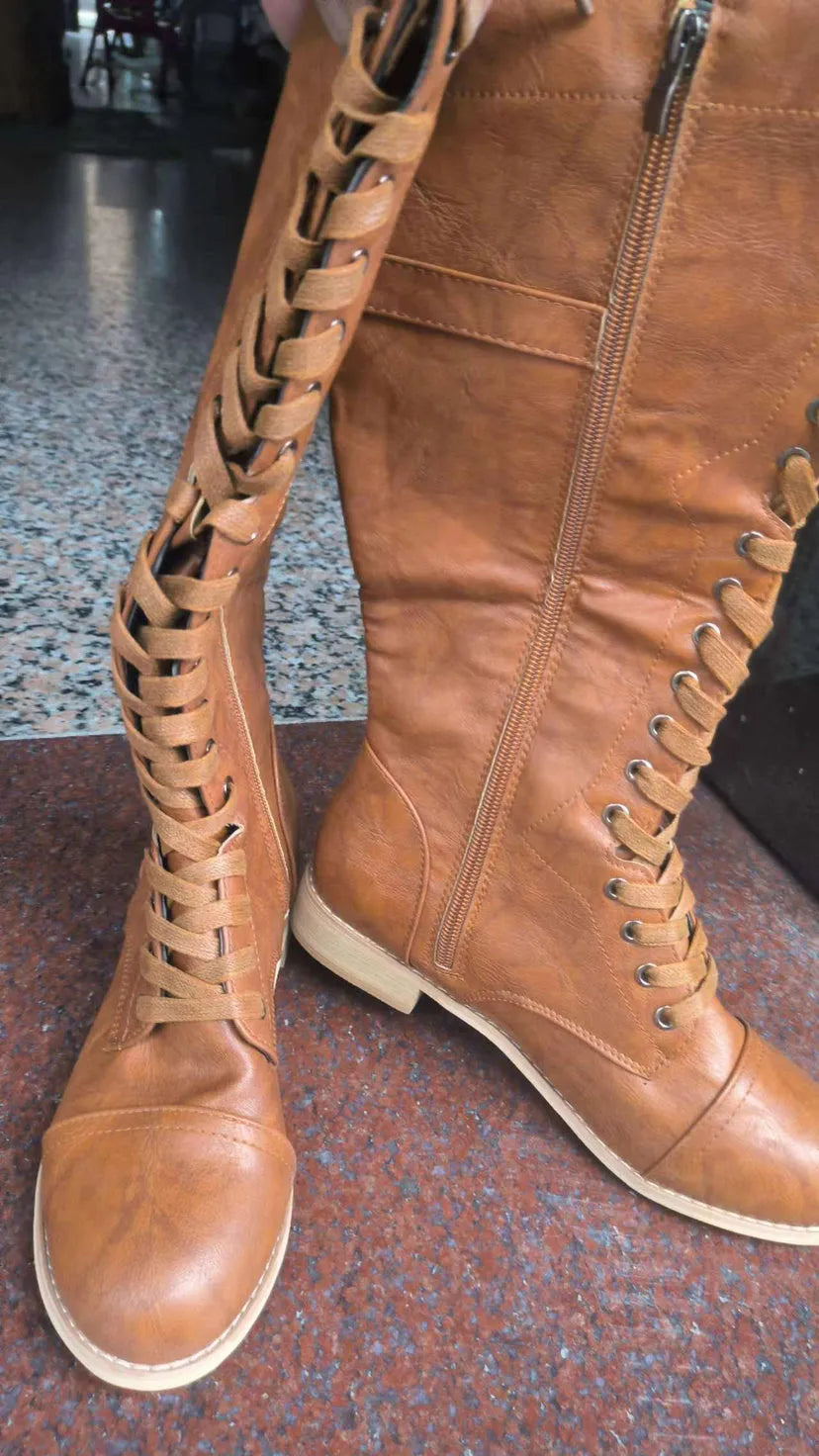 Women's black knight ankle boots with a cross strap detail over the front, made from artificial PU.