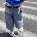 Men's blue washed denim pirate shorts with a high waist, zip fly, and straight cropped legs.