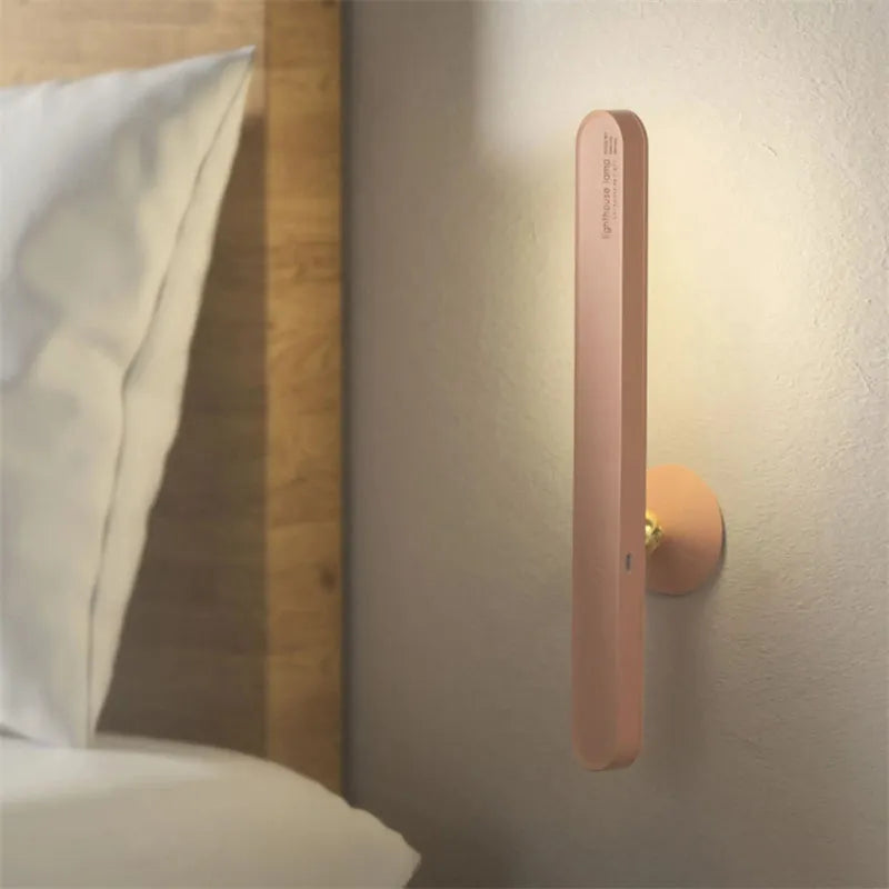 White geometric desk lamp with magnetic base mounted on a metal wall surface.
