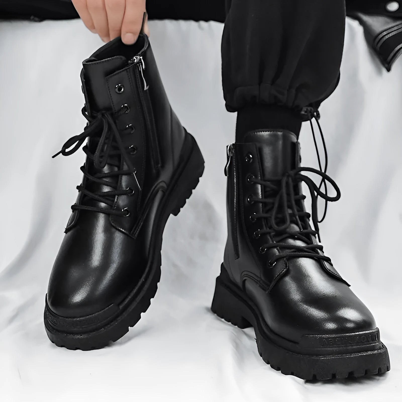 Men's black mid-top leather-look Tide British boots with a flat style and rubber sole.