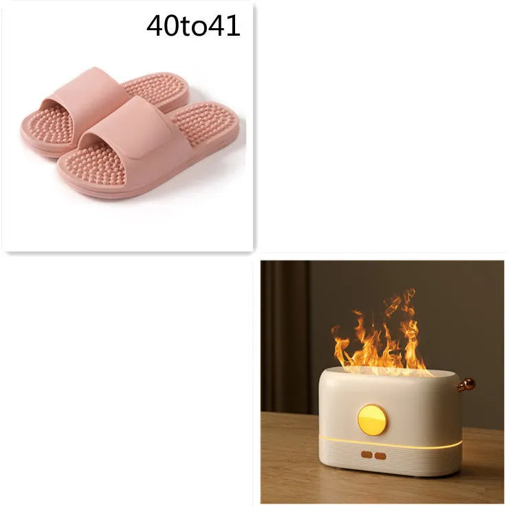 Black USB humidifier with simulated flame effect on a wooden desk.