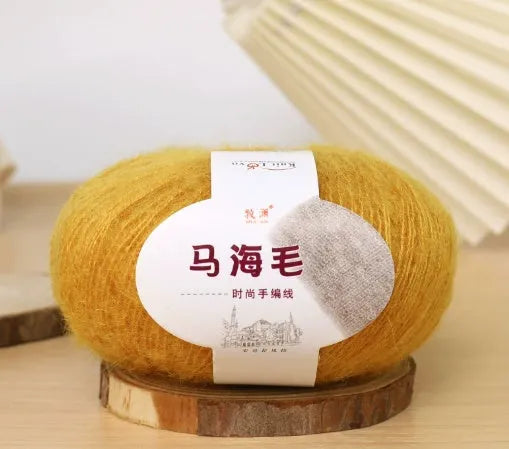 Ball of mohair yarn for DIY scarf knitting in one of 34 colours, including white, pink, blue, and green.