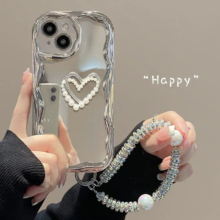 Silver grey silicone phone case for iPhone 14 Pro Max with three-dimensional heart and pearl chain bracelet.