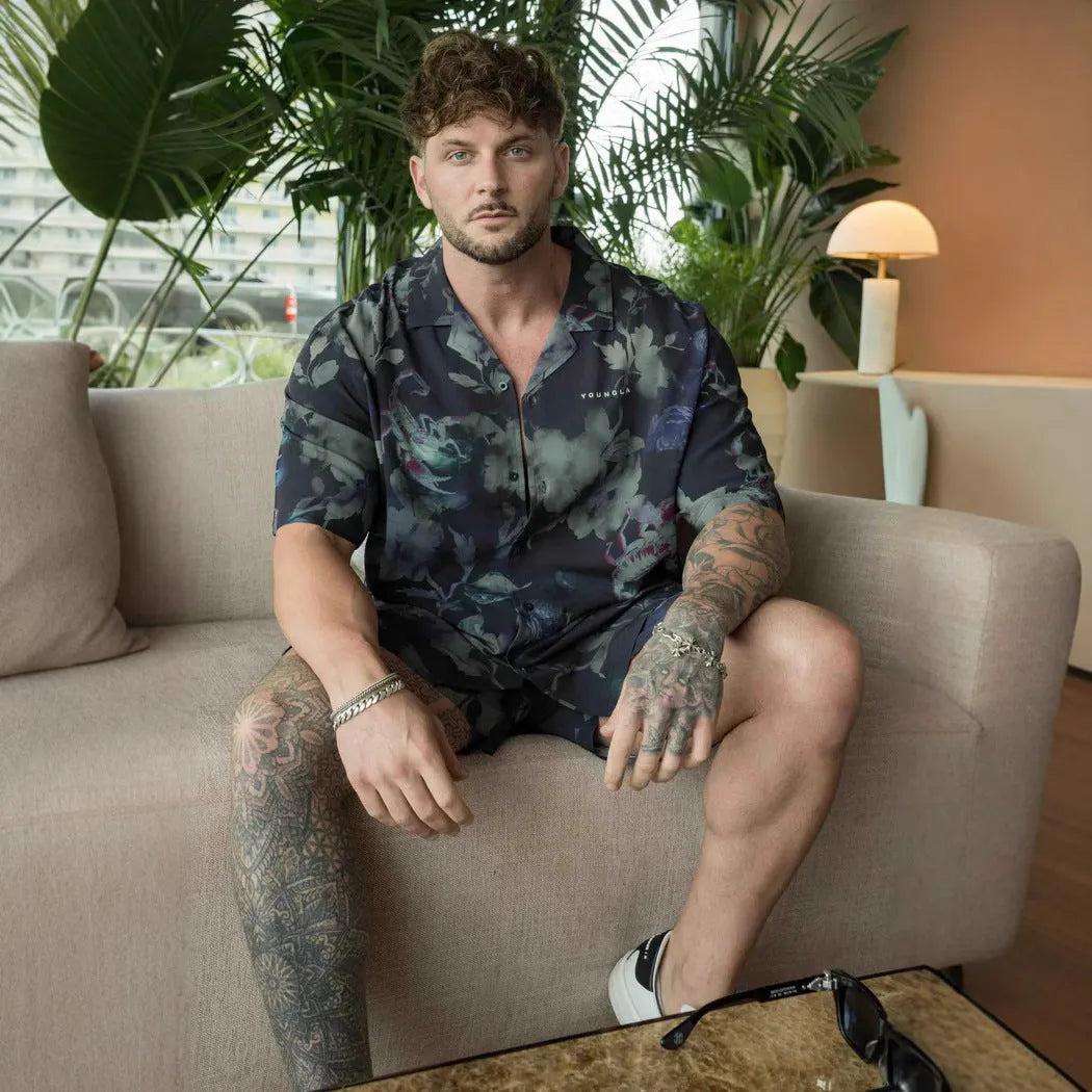 Men's loose-fit short sleeve top with floral print in light colour, laid flat.