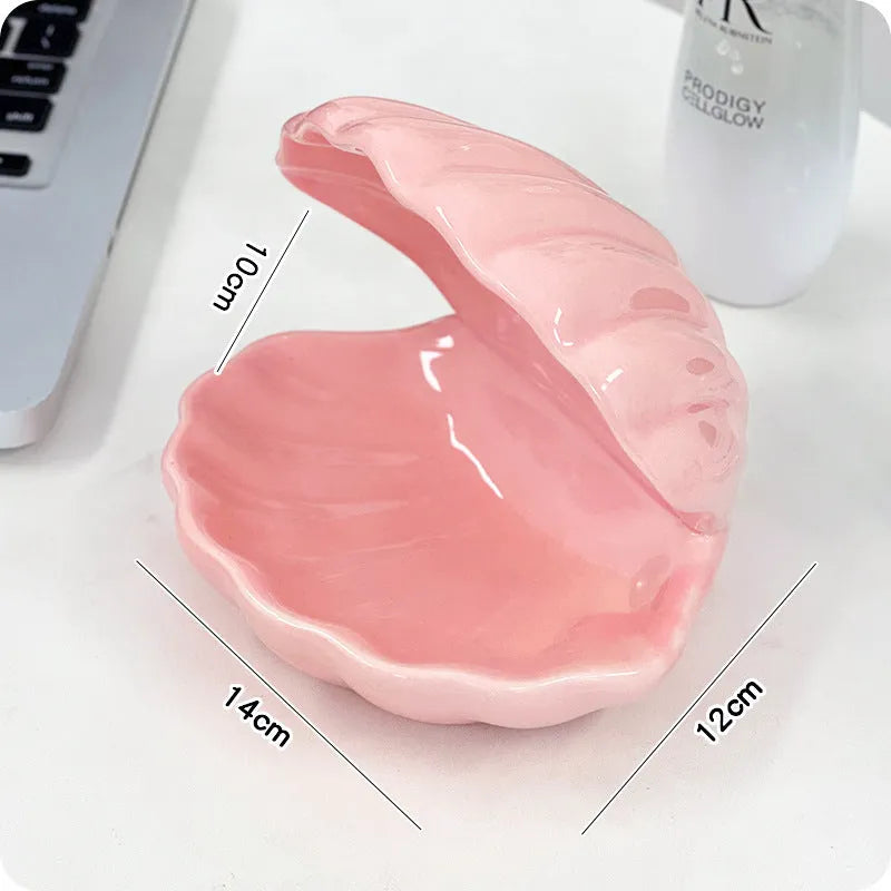 White porcelain storage tray with optional small night light, shown in pink and white shell colours on a wooden surface.