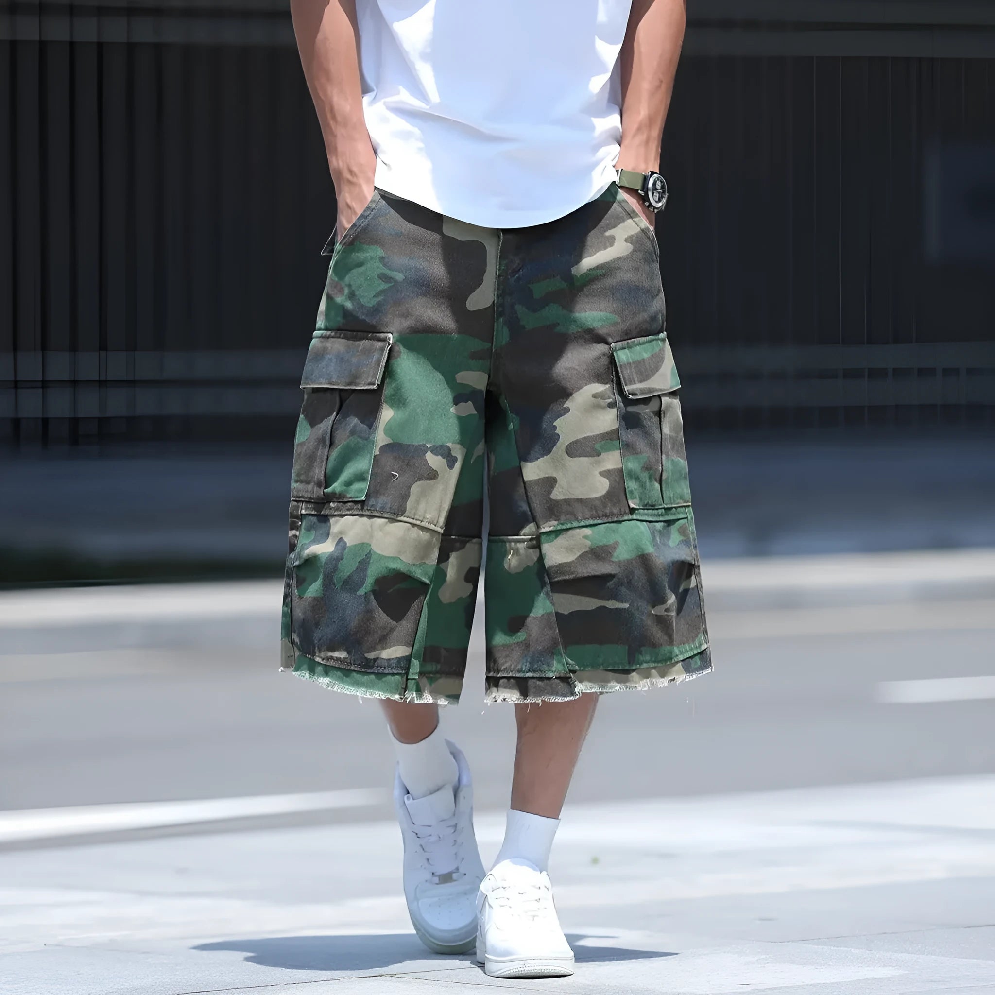 Man wearing loose, cropped camouflage shorts in a khaki colourway, showcasing the summer workwear style.