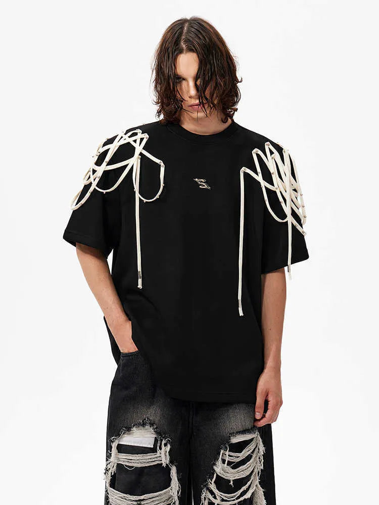 Black loose fit short-sleeved T-shirt with padded shoulders featuring rivet and ribbon detail.