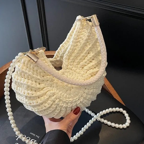 Handmade woven cloth bag in retro style with open pocket and double shoulder straps.