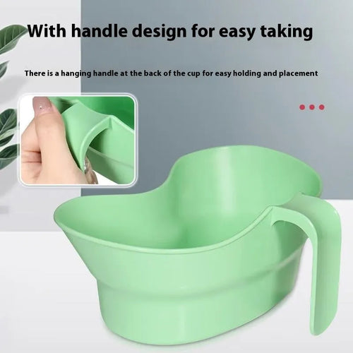Green plastic gargle cup for bedside patient mouth care and hygiene.