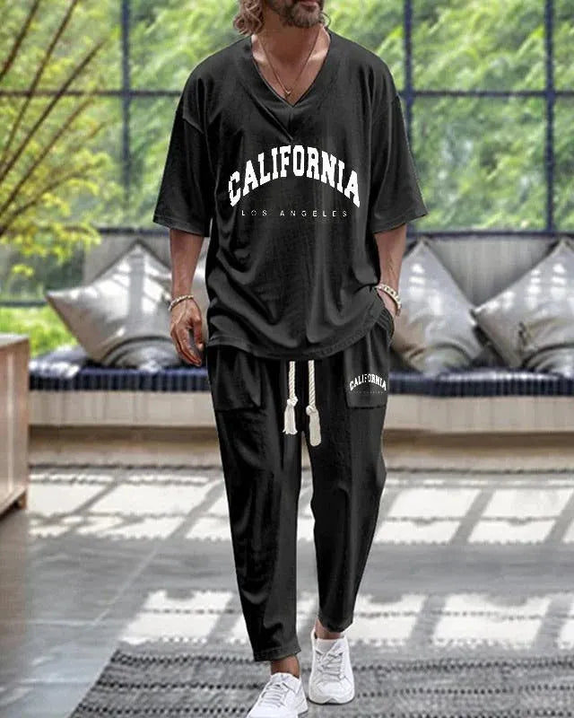 Cropped sleeve V-neck jacket and trousers suit in thin polyester fabric on a hanger.