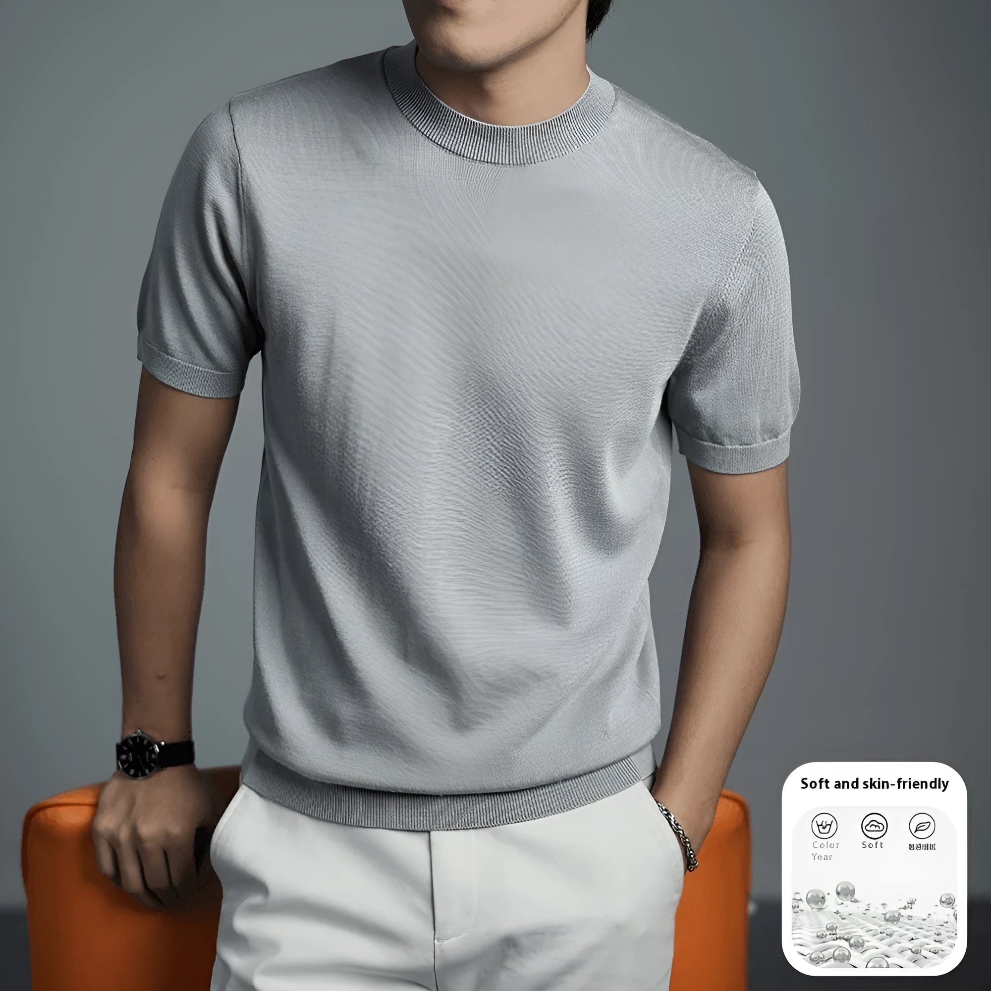 Men's silver grey knitted round neck t-shirt with short sleeves on a hanger.