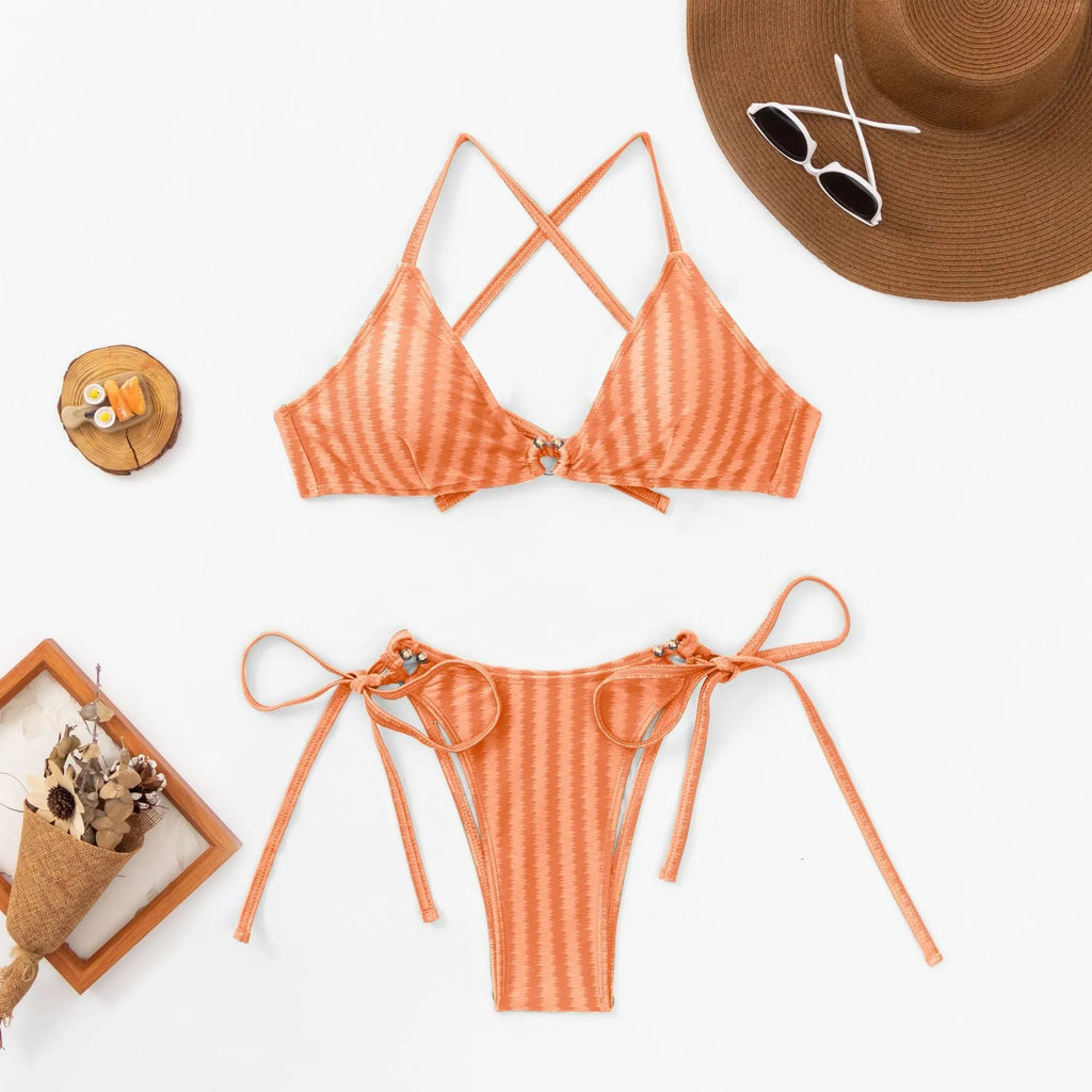 Women's red lace-up bikini top and matching briefs on a mannequin