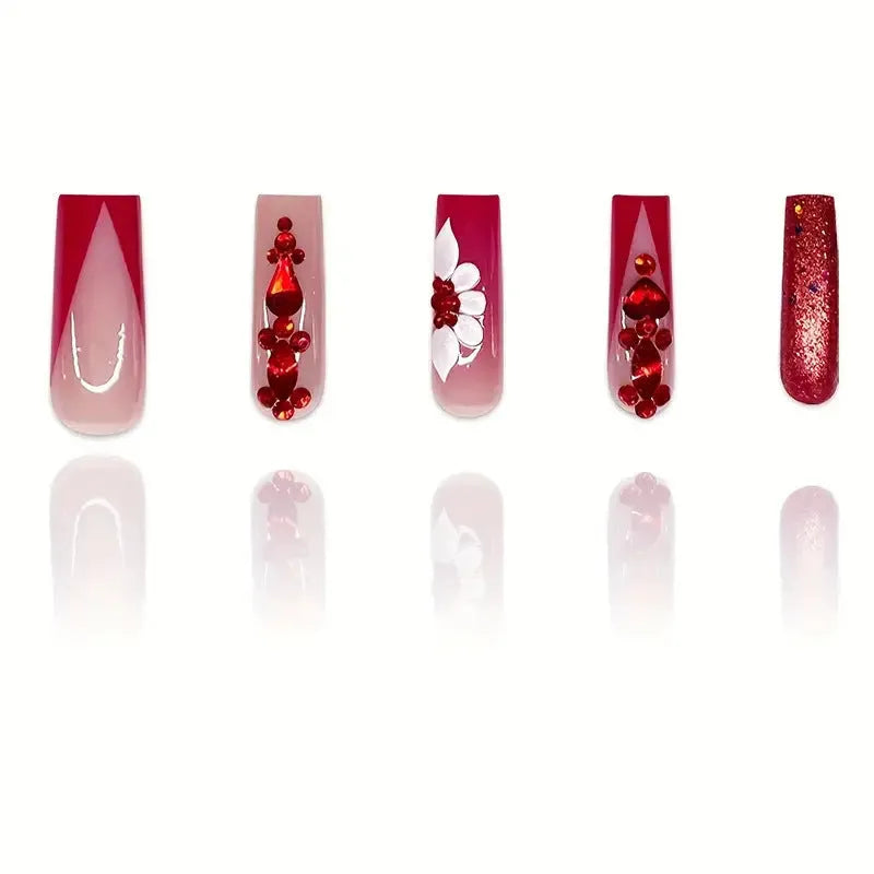Long European square fake nails with sweet floral pattern and prismatic red diamond crystal accents.