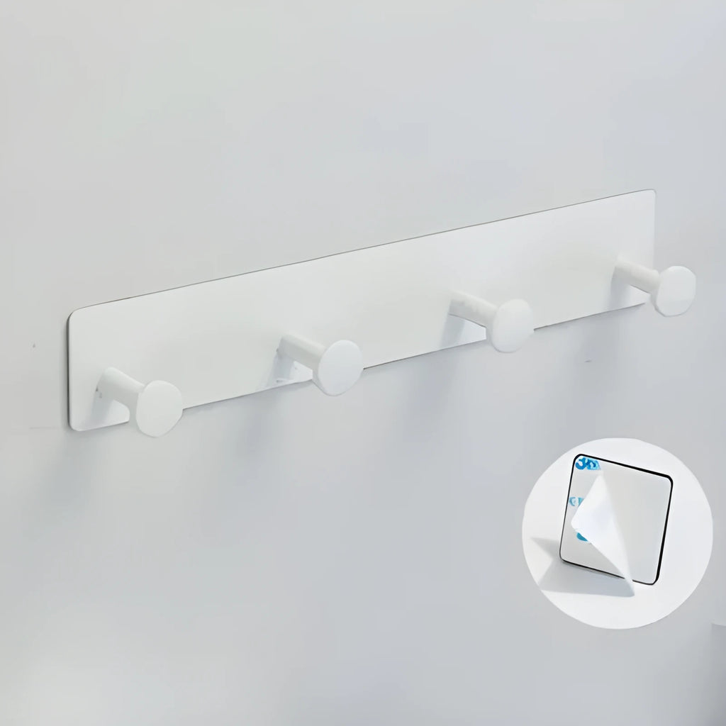 Black screwless adhesive wall hook with three hooks mounted on a glass shower door