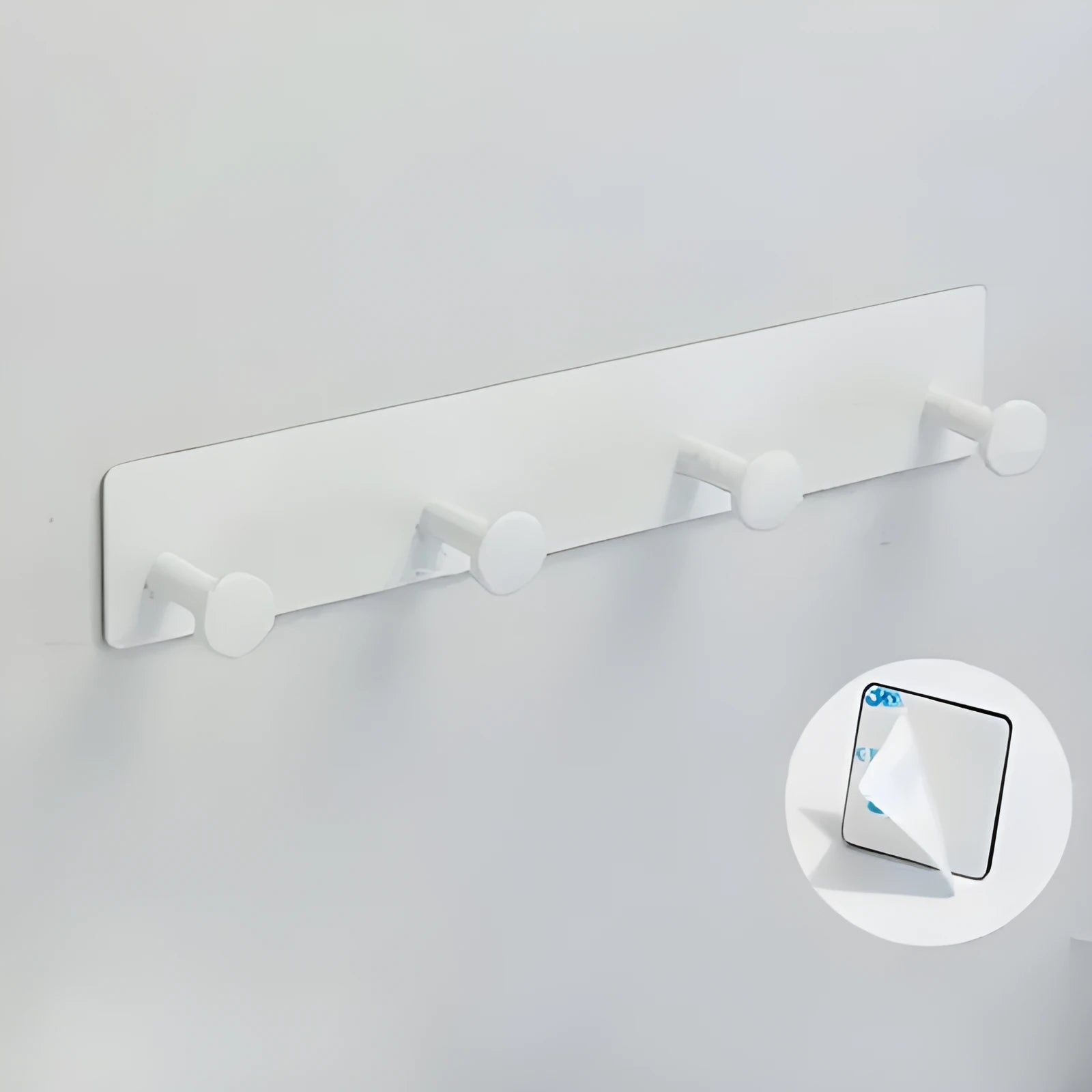 Black screwless adhesive wall hook with three hooks mounted on a glass shower door